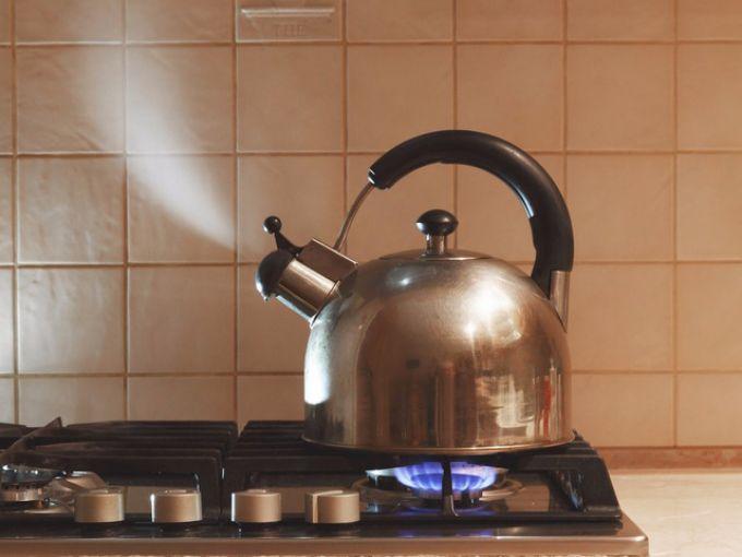 Gia chủ bật bếp và nấu nước phà trà,